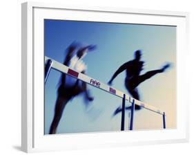 Low Angle View of Athletes Jumping over Hurdles-null-Framed Photographic Print