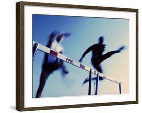 Low Angle View of Athletes Jumping over Hurdles-null-Framed Photographic Print