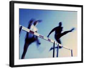 Low Angle View of Athletes Jumping over Hurdles-null-Framed Photographic Print