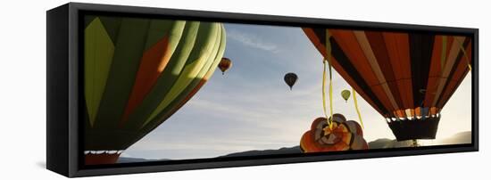 Low angle view of hot air balloons in a balloon festival, Taos Balloon Fiesta, Taos, Taos County...-null-Framed Stretched Canvas