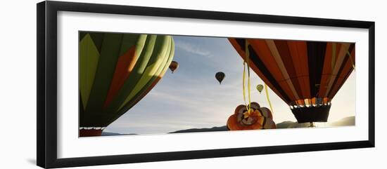 Low angle view of hot air balloons in a balloon festival, Taos Balloon Fiesta, Taos, Taos County...-null-Framed Photographic Print