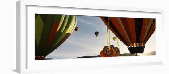 Low angle view of hot air balloons in a balloon festival, Taos Balloon Fiesta, Taos, Taos County...-null-Framed Photographic Print