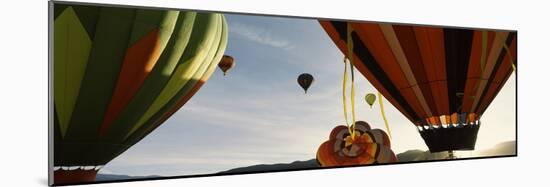 Low angle view of hot air balloons in a balloon festival, Taos Balloon Fiesta, Taos, Taos County...-null-Mounted Photographic Print