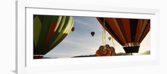 Low angle view of hot air balloons in a balloon festival, Taos Balloon Fiesta, Taos, Taos County...-null-Framed Photographic Print