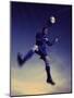Low Section View of a Soccer Player Jumping in Mid Air to Head a Soccer Ball-null-Mounted Photographic Print