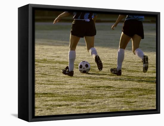 Low Section View of Two Female Soccer Players Kicking a Soccer Ball-null-Framed Stretched Canvas