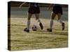 Low Section View of Two Female Soccer Players Kicking a Soccer Ball-null-Stretched Canvas