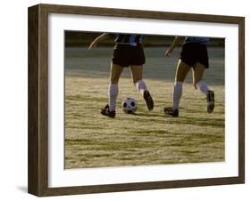 Low Section View of Two Female Soccer Players Kicking a Soccer Ball-null-Framed Premium Photographic Print
