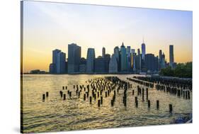 Lower Manhattan skyline across the East River at sunset, New York City, New York, United States of -Fraser Hall-Stretched Canvas