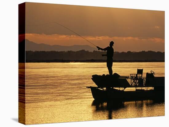 Lower Zambezi National Park, Fly Fishing for Tiger Fish from a Barge on the Zambezi River at Dawn, -John Warburton-lee-Stretched Canvas