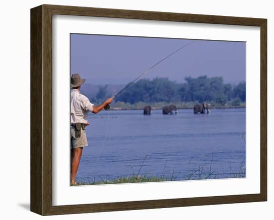 Lower Zambezi National Park, Fly-Fishing for Tiger Fish on the Zambezi River Against a Backdrop of -John Warburton-lee-Framed Photographic Print