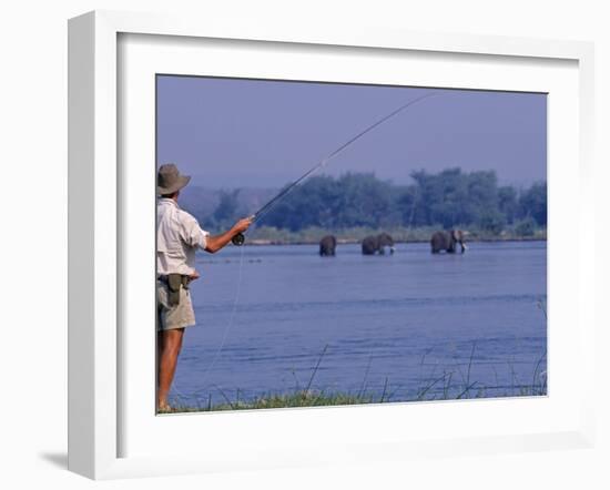 Lower Zambezi National Park, Fly-Fishing for Tiger Fish on the Zambezi River Against a Backdrop of -John Warburton-lee-Framed Photographic Print