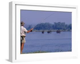 Lower Zambezi National Park, Fly-Fishing for Tiger Fish on the Zambezi River Against a Backdrop of -John Warburton-lee-Framed Photographic Print