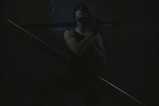 Young Man Posing in Dark Setting-Luis Beltran-Photographic Print