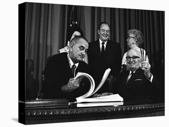 Lyndon Johnson Signing the Medicare Bill with Former President Truman, July 7,1965-null-Stretched Canvas