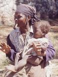 Haitian Woman Smoking a Pipe while Holding a Baby-Lynn Pelham-Framed Photographic Print