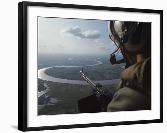 Machine Gunner Scanning For Hostiles While His Helicopter is on Patrol over the Mekong Delta-Larry Burrows-Framed Photographic Print