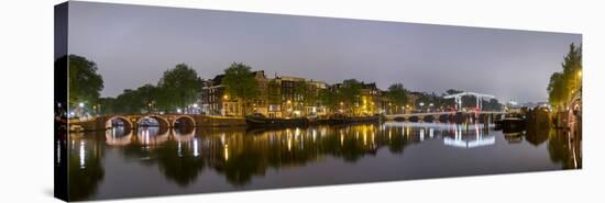 Magere Brug over the River Amstel and Canal Houses Illuminated on Foggy Evening-null-Stretched Canvas