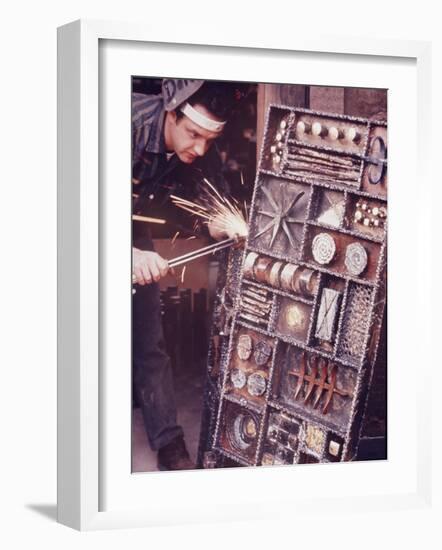 Maker of Metal Furniture, Paul Evans, Hope, PA., Burnishes Door of Steel Chest with Acetylene Torch-Nina Leen-Framed Photographic Print