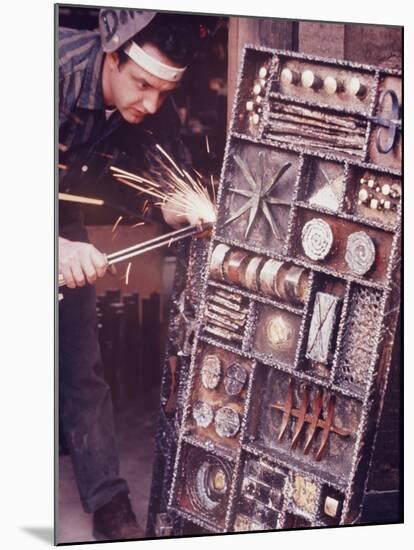 Maker of Metal Furniture, Paul Evans, Hope, PA., Burnishes Door of Steel Chest with Acetylene Torch-Nina Leen-Mounted Photographic Print