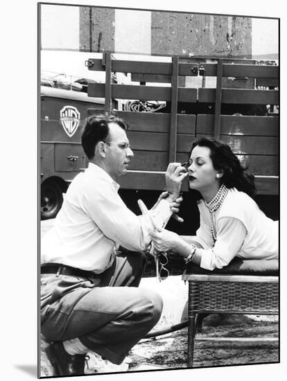 Makeup Artist Ben Nye Applying Eye Makeup to Actress Hedy Lamarr Who Observes in a Mirror-null-Mounted Photo