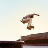 Skateboarder Performs a Trick in the City on a Sunny Day-Maksim Shirkov-Photographic Print