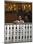 Malagasy Girl with Maize Cobs Hanging to Dry from the Balcony of a Typical Betsileo Double-Storied -Nigel Pavitt-Mounted Photographic Print