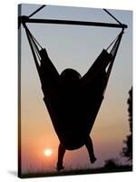 Malawi, Lake Malawi National Park, Young Guest Relaxes in a Hammock at Pumulani Lodge, (MR)-John Warburton-lee-Stretched Canvas
