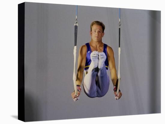 Male Gymnast Performing on the Rings-null-Stretched Canvas
