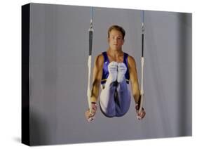 Male Gymnast Performing on the Rings-null-Stretched Canvas