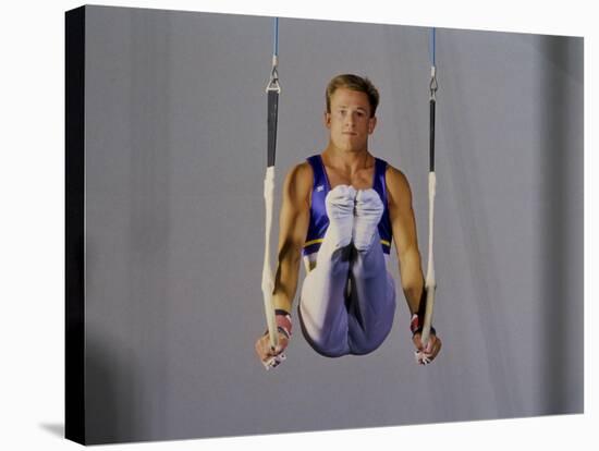 Male Gymnast Performing on the Rings-null-Stretched Canvas