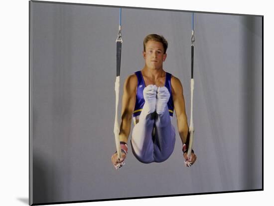 Male Gymnast Performing on the Rings-null-Mounted Photographic Print