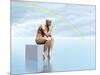 Male Musculature Sitting on a Cube, Thinking under a Rainbow-null-Mounted Art Print