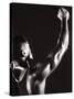 Male Runner Holding Up a Relay Baton-null-Stretched Canvas