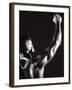 Male Runner Holding Up a Relay Baton-null-Framed Photographic Print