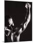 Male Runner Holding Up a Relay Baton-null-Mounted Photographic Print