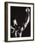 Male Runner Holding Up a Relay Baton-null-Framed Photographic Print