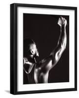 Male Runner Holding Up a Relay Baton-null-Framed Photographic Print