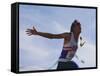Male Runner Victorious at the Finish Line in a Track Race-null-Framed Stretched Canvas