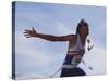 Male Runner Victorious at the Finish Line in a Track Race-null-Stretched Canvas