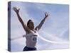 Male Runner Victorious at the Finish Line in a Track Race-null-Stretched Canvas
