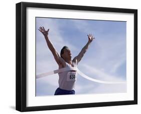 Male Runner Victorious at the Finish Line in a Track Race-null-Framed Photographic Print