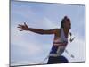 Male Runner Victorious at the Finish Line in a Track Race-null-Mounted Photographic Print