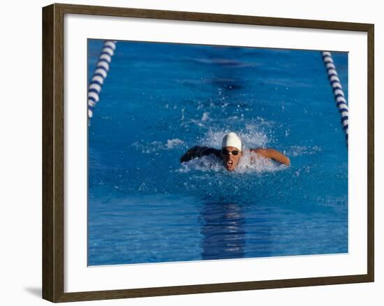 Male Swimmer Competing in a Butterfly Race-null-Framed Photographic Print