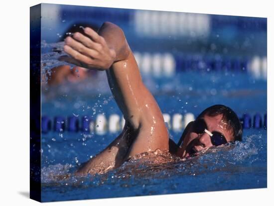 Male Swimmer Competing in a Freestyle Race-null-Stretched Canvas