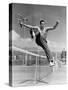 Male Tennis Player Jumping over Net-null-Stretched Canvas