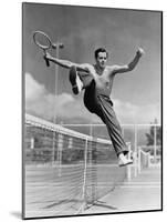 Male Tennis Player Jumping over Net-null-Mounted Photo