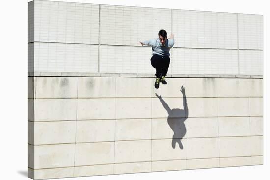 Male Tracer Free Runner Jumping Forward from High Rooftop over Cement Building Background, Young Tr-GaudiLab-Stretched Canvas