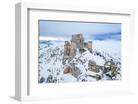 Man admiring the snowy medieval castle of Rocca Calascio after heavy snowfall, Rocca Calascio-Paolo Graziosi-Framed Photographic Print