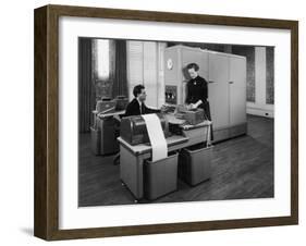 Man and a Women Working Together with a Pegasus Computer-null-Framed Photographic Print